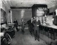Men standing inside an old bank room