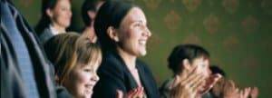 Mother and daughter clapping