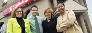 Four Scotiabank employees in front of a branch