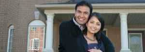 Couple in front of new house