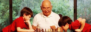 Man playing chess with grandsons
