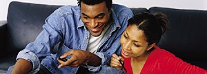 Couple working together on couch