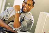 Man with sleeves rolled up at computer