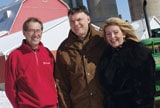 Two Scotiabank customers with Scotiabanker at their farm