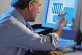 Man pointing at computer screen