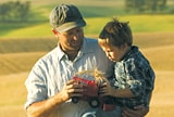 Father and son in a field.