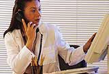 A woman using the telephone.