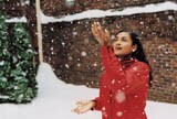 Woman catching snowflakes