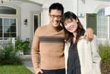 Happy couple on front lawn