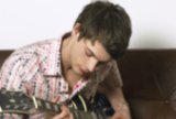 Teen playing guitar