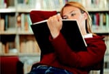 University student reading in library