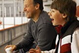 Father and son watching a hockey game