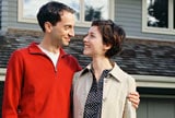 Couple standing in front of house