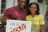 couple in front of their new home