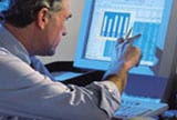 man looking at finances on computer