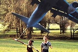 children with toy airplane