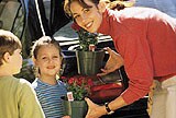 mother and children getting ready to plant flowers