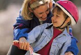 mother helping son ride a bike