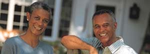 Couple standing in front of house