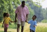 Father walking with young son and daughter