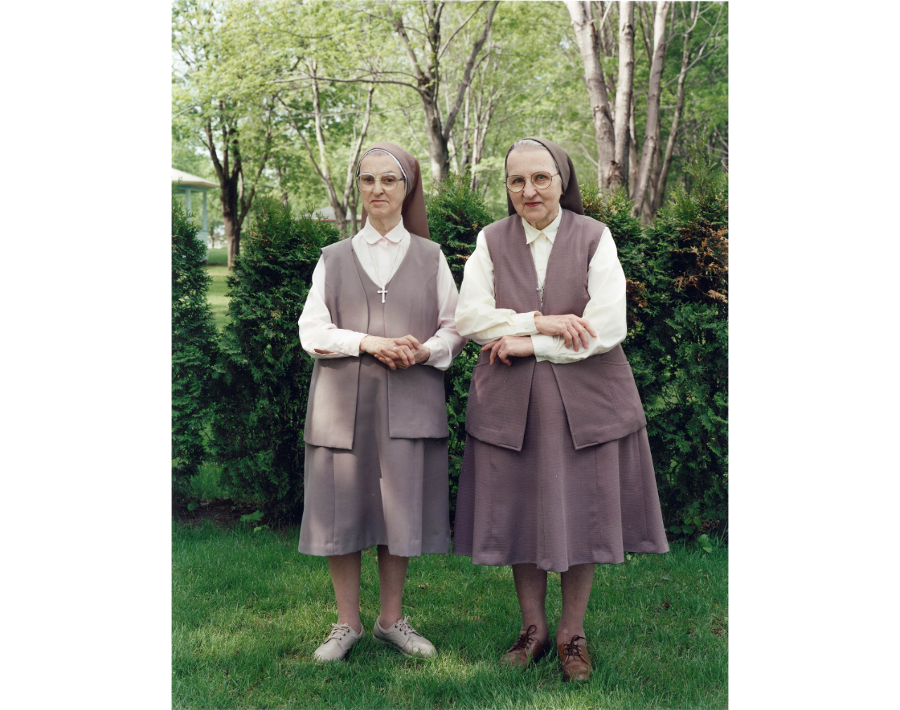 Two nuns standing for photograph in garden