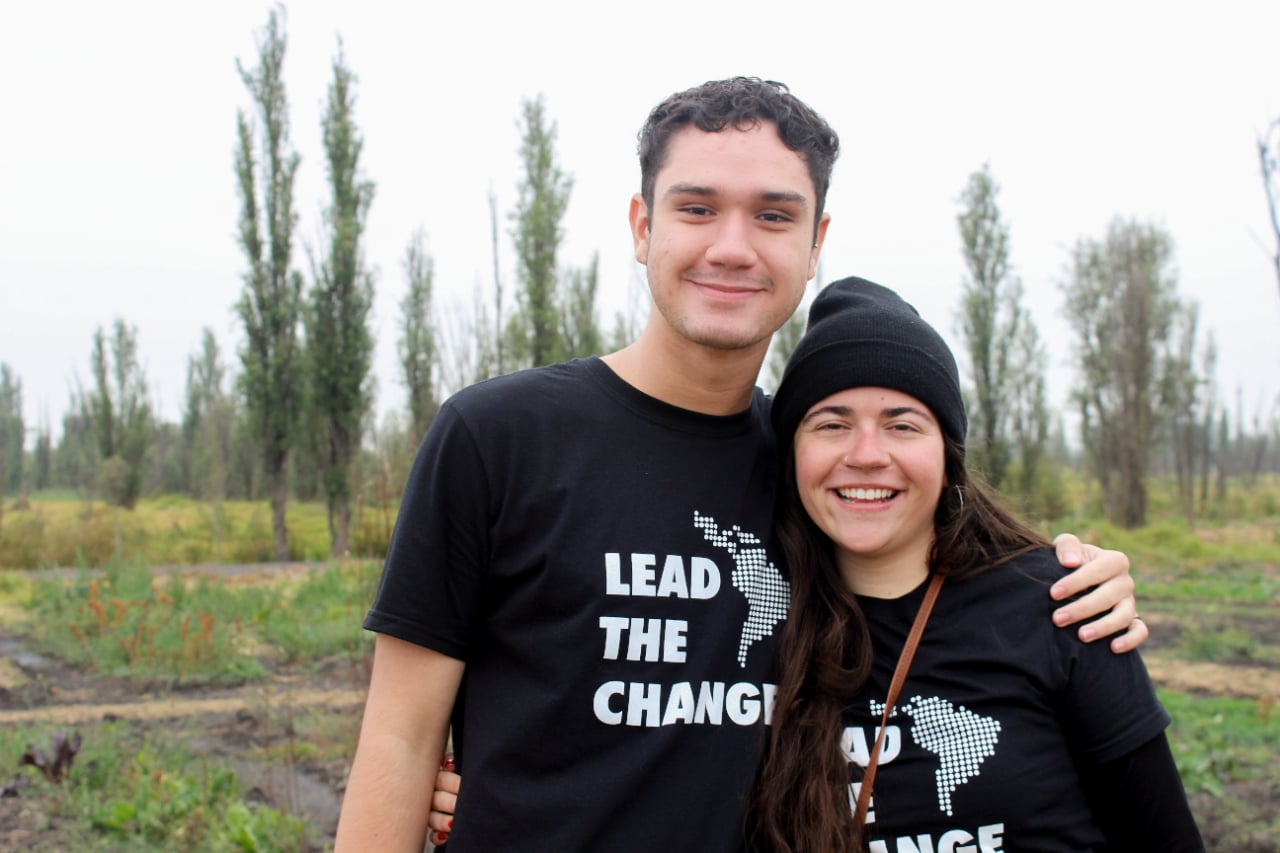 Two people outside in "Lead the change" shirts